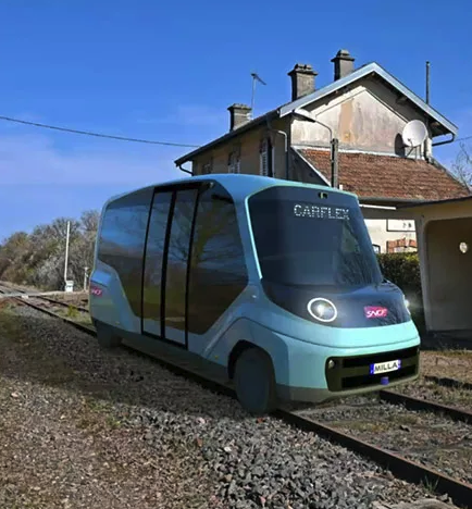 A strange van like thing running on a rail track