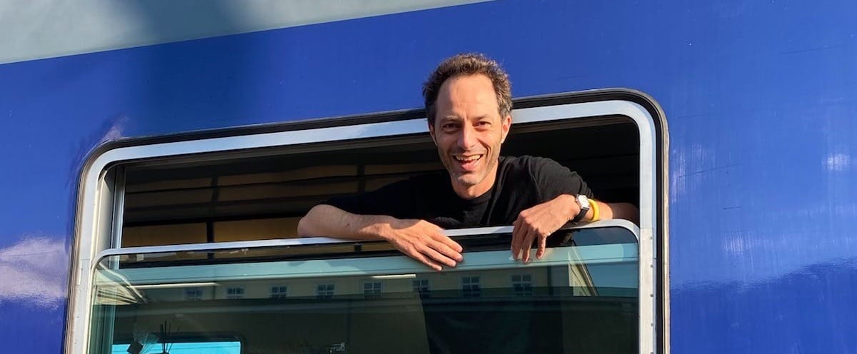 Jon head out of an open train window