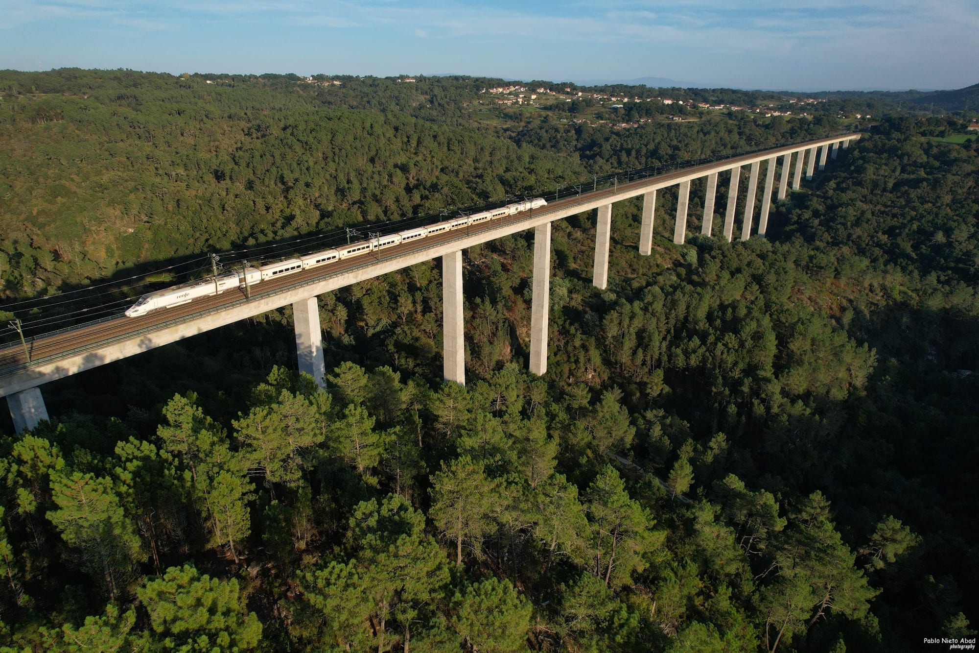 A Talgo train on a bridge