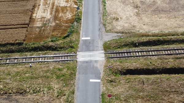 Drone pic of a small road crossing a small railway line